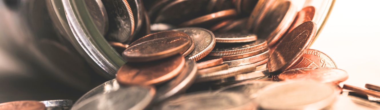 photo of USA coins overflowing from a mason jar