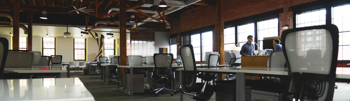 Two men working in an open floor plan office