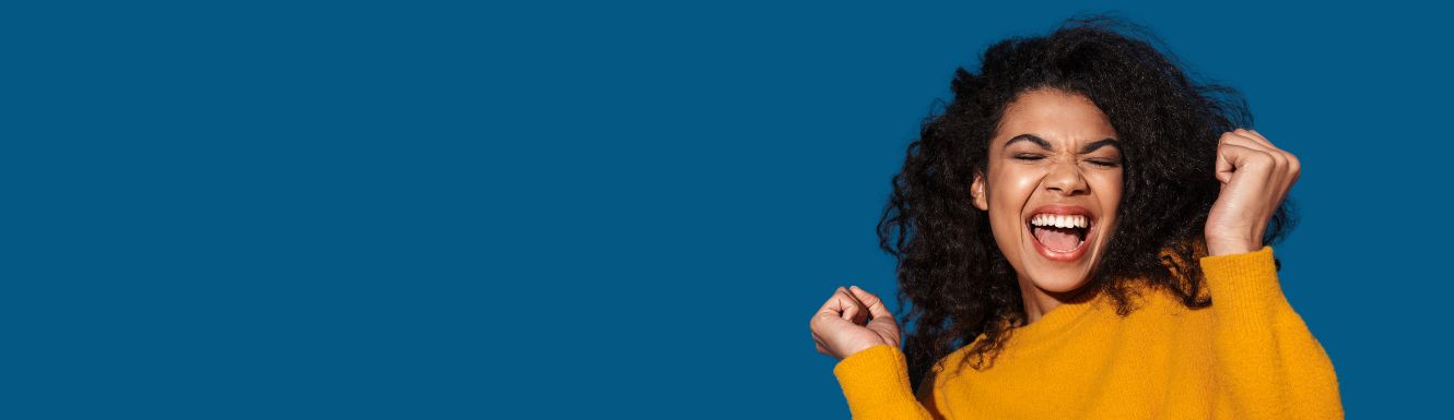 image of a young excited cheerful woman posing isolated over blue wall background