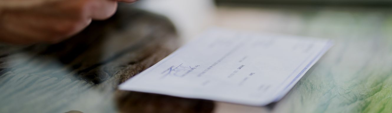 a signed check on a table.