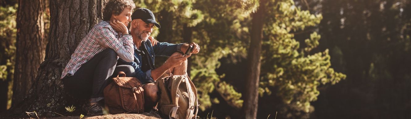 Man and woman reading a map while hiking