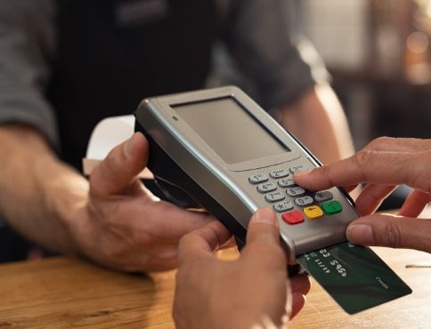 Woman entering pin number on credit card machine