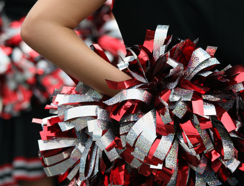 Cheerleader holding pom pom