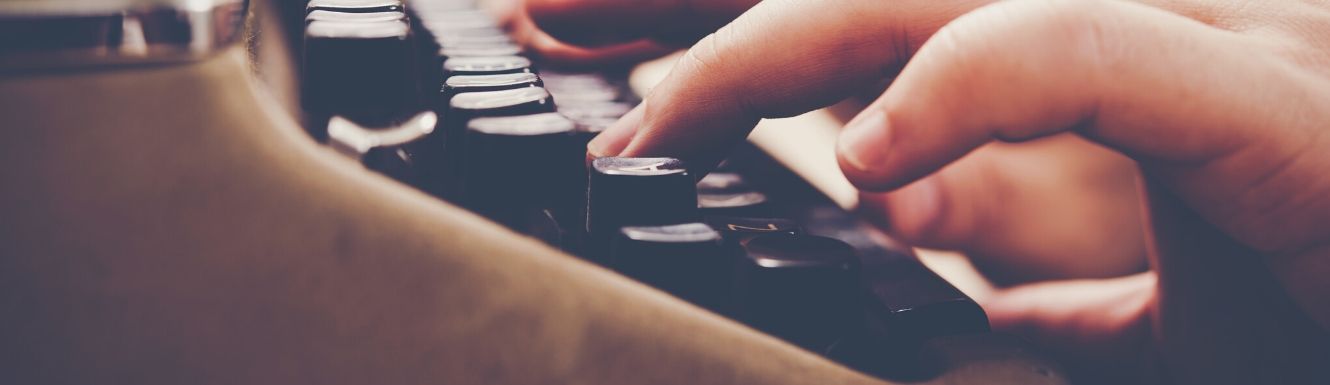 hands typing on an electric typewriter