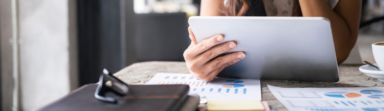 Businessperson Analyzing Investment Documents on tablet