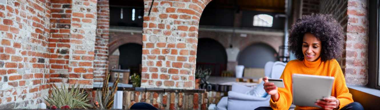 woman looking at credit card in living room